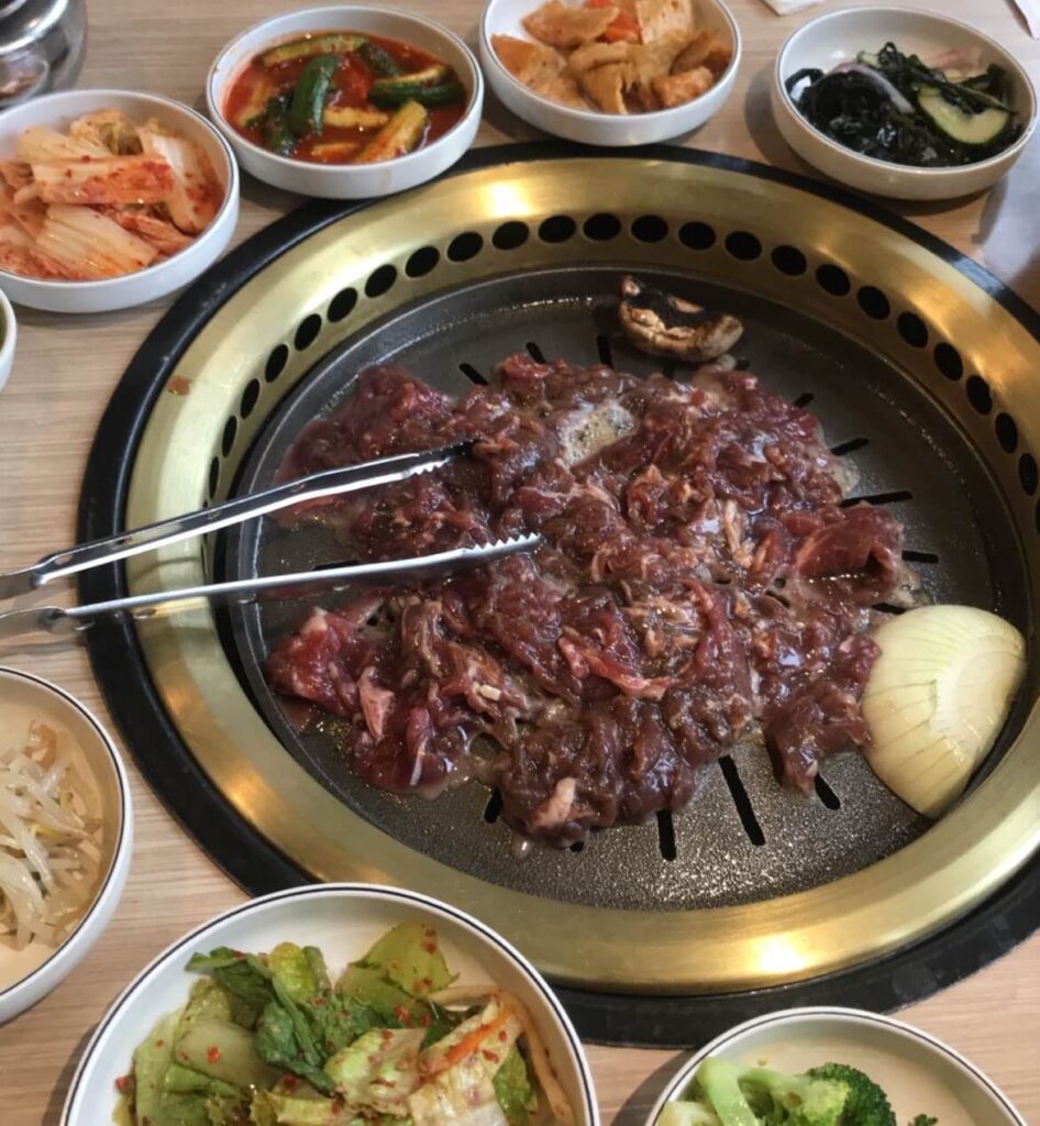 bulgogi cooking over a korean bbq grill in Central Sq 