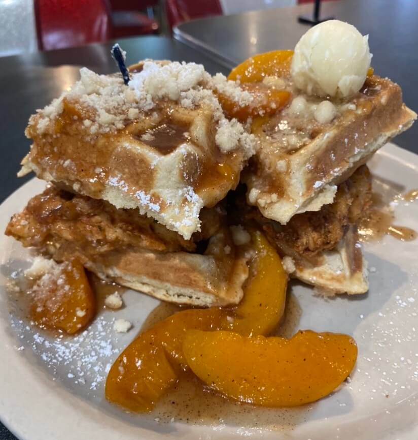 Peach cobbler chicken and waffle from Atlanta breakfast club, a restaurant perfect for a weekend in Atlanta